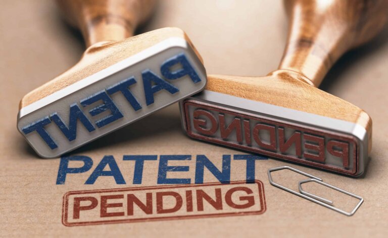 one rubber stamp reads patent and the other pending to represent the question of what can be patented.